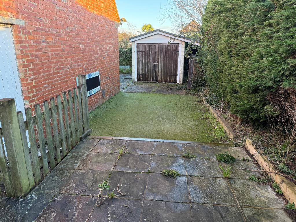 Lot: 35 - FORMER METHODIST CHURCH WITH POTENTIAL - Rear patio and fake grass with store